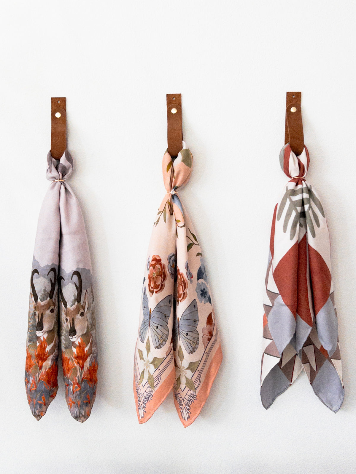 San Luis, Columbine and Heirloom silk scarves displayed on a table at Matty Miller Studio in Denver
