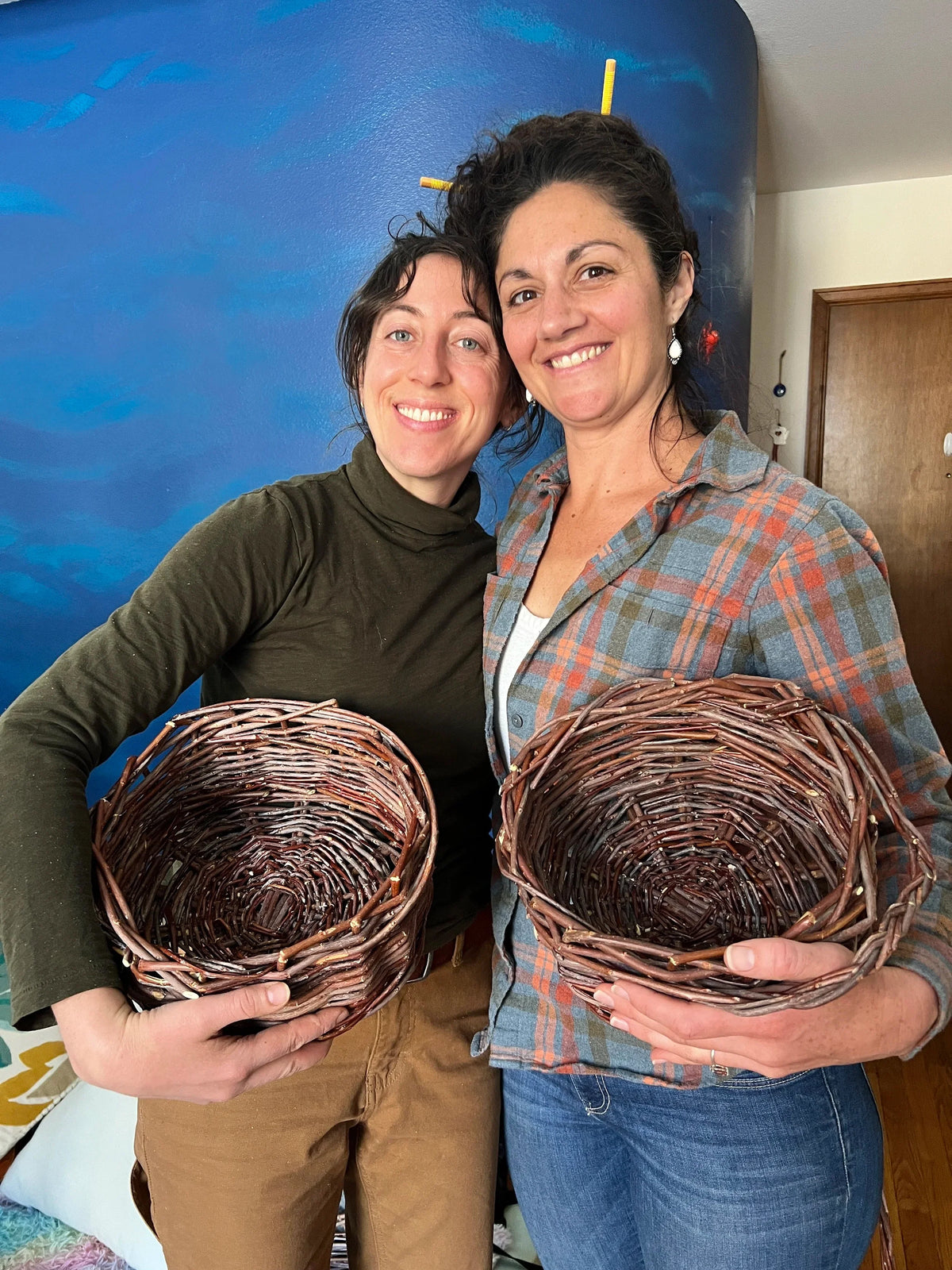 Matty Miller and friend weaving willow baskets at a Groundwork workshop in Colorado