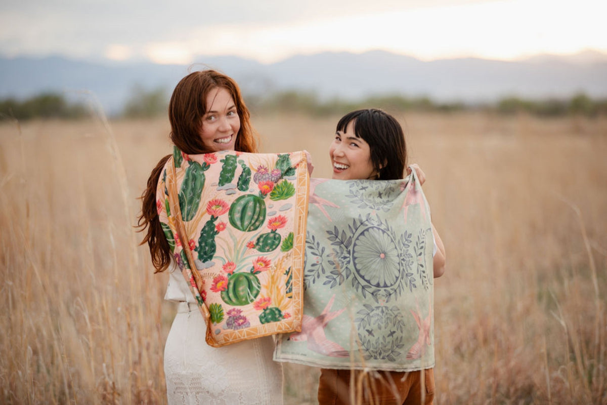 Cactus Garden and Skylark 100% silk scarves by Matty Miller, held open outdoors