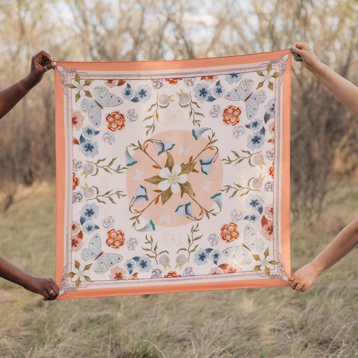 Columbine 100% silk scarf, Flowers & Butterflies by Matty Miller, held open outdoors