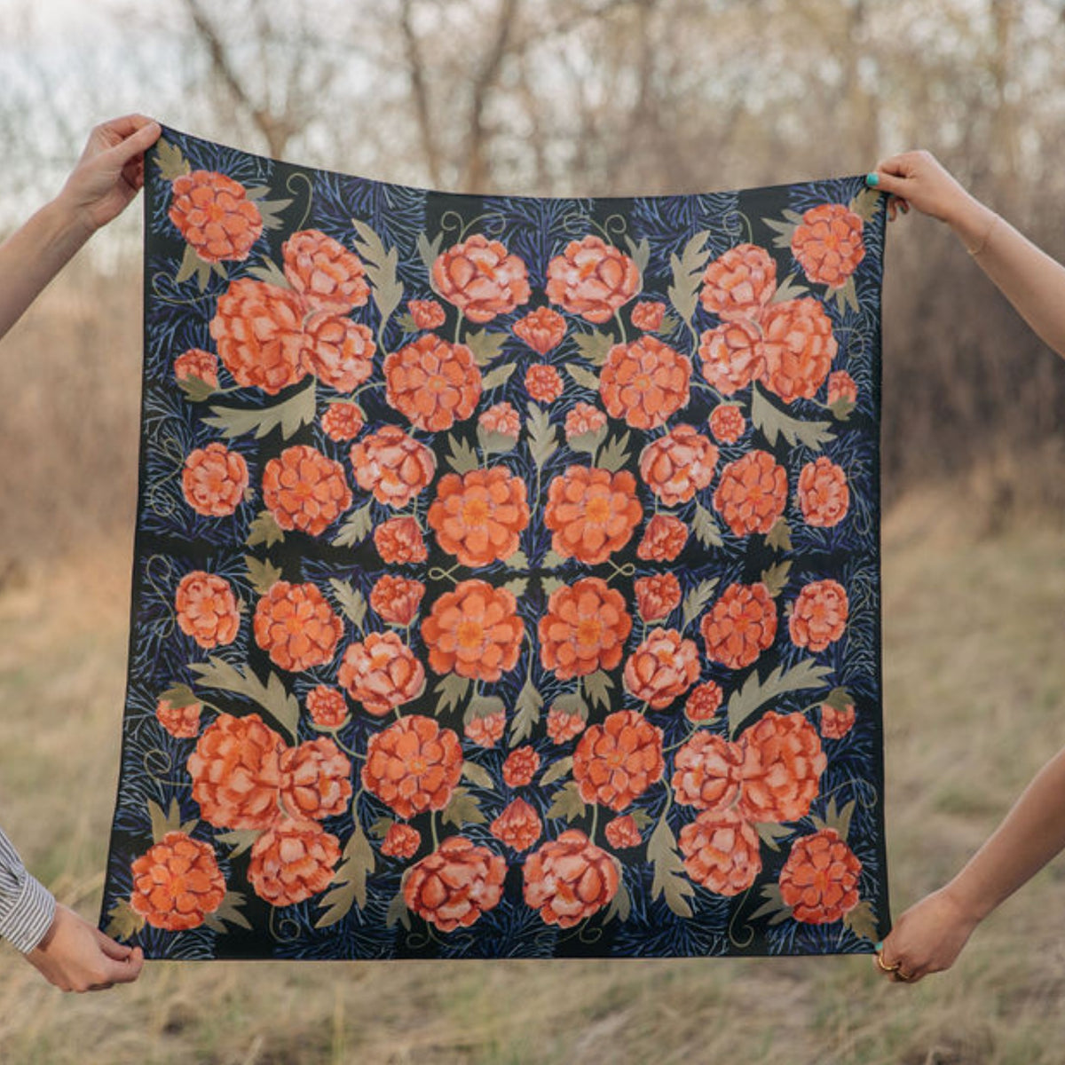 Guadalupe 100% silk scarf, Dark Floral Pattern by Matty Miller, held open outdoors