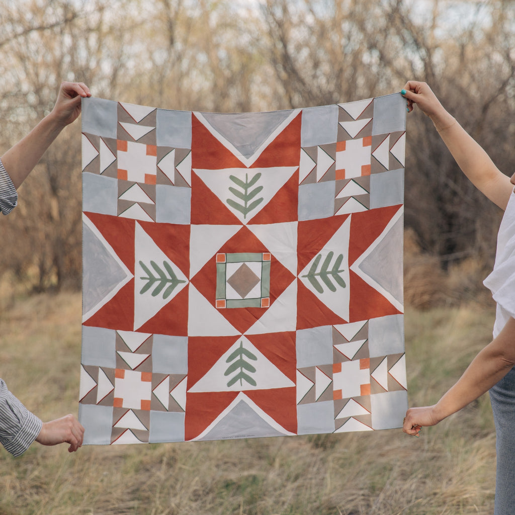 Heirloom 100% silk scarf, Folk Quilt Pattern by Matty Miller, held open outdoors