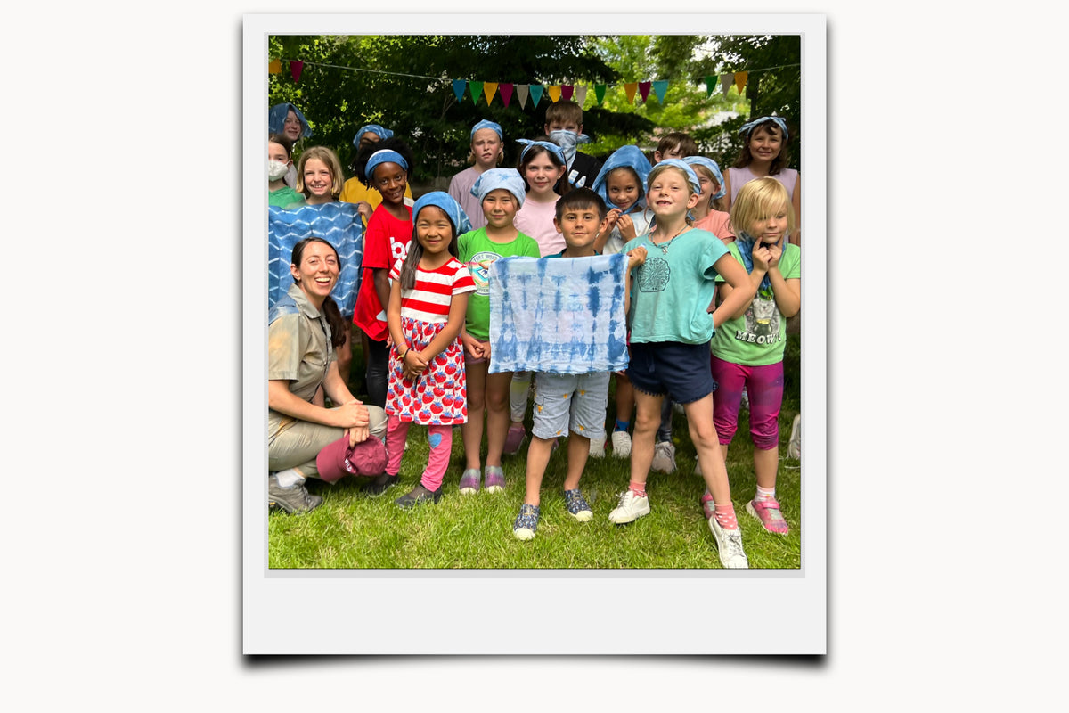 Matty with a group of happy kids and their shibori dye project at art camp