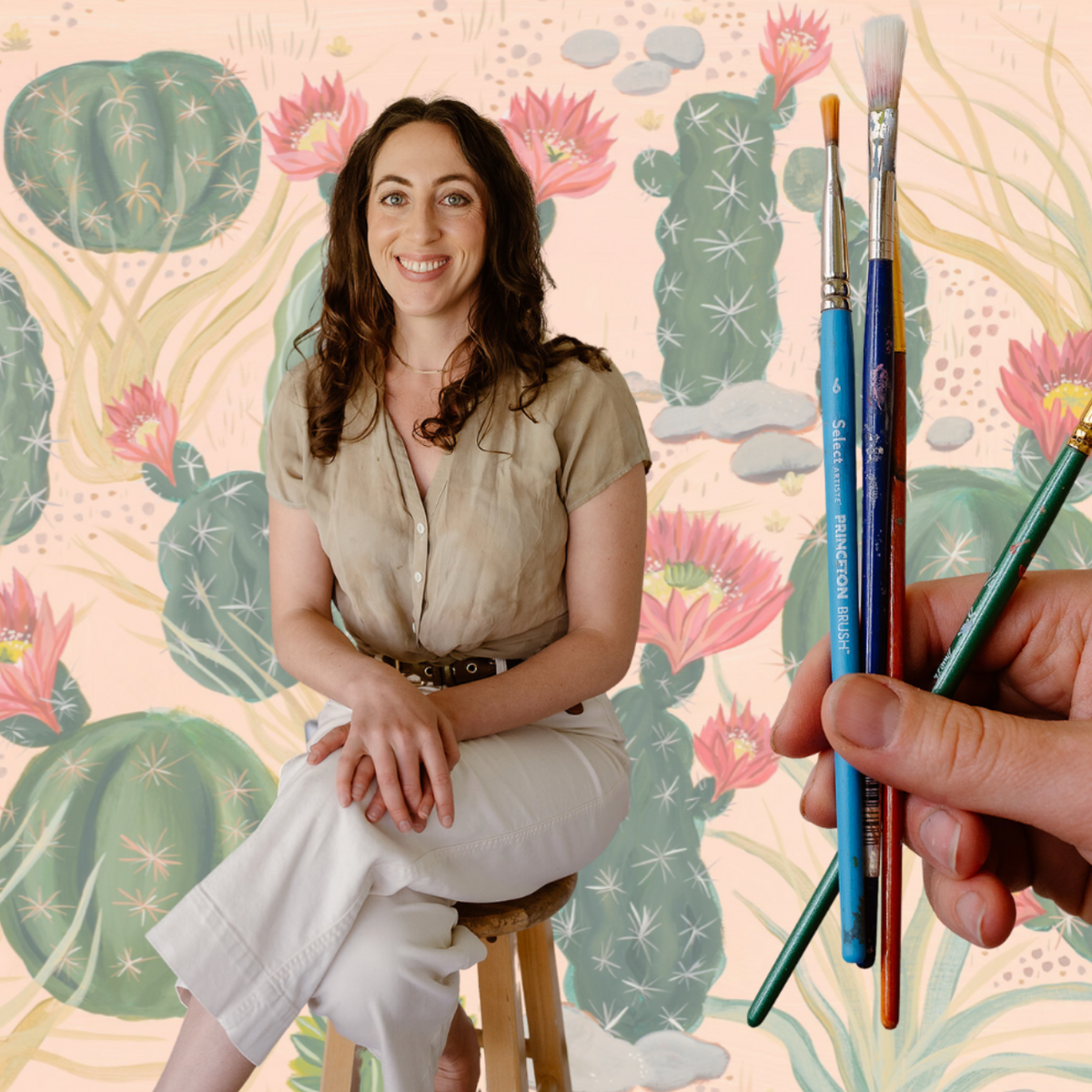 Denver art teacher Matty Miller holding paintbrushes in front of her cactus painting