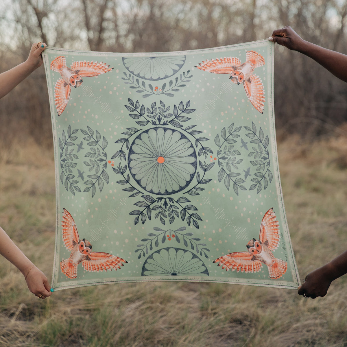 Plume 100% silk scarf, Owls & Florals by Matty Miller, held open outdoors