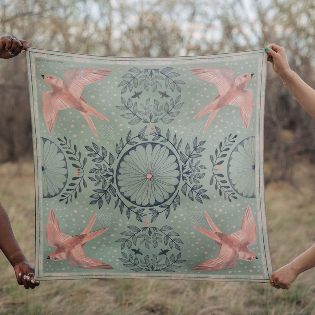 Skylark 100% silk scarf, Birds & Florals by Matty Miller, held open outdoors