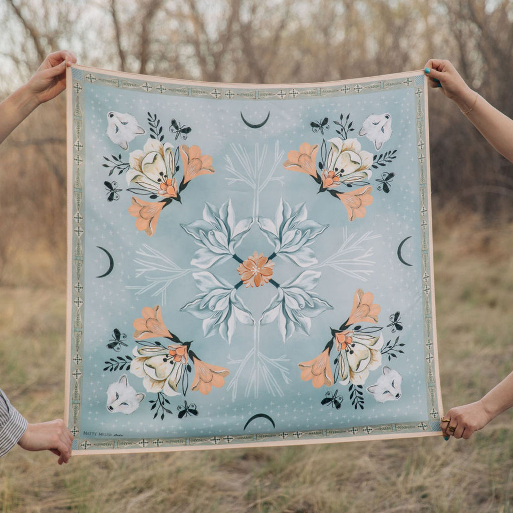 Tundra 100% silk scarf, Arctic Animal Floral Pattern by Matty Miller, held open outdoors