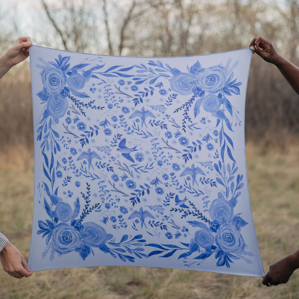 Zephyr 100% silk scarf, Blue Floral Bird Pattern by Matty Miller, held open outdoors